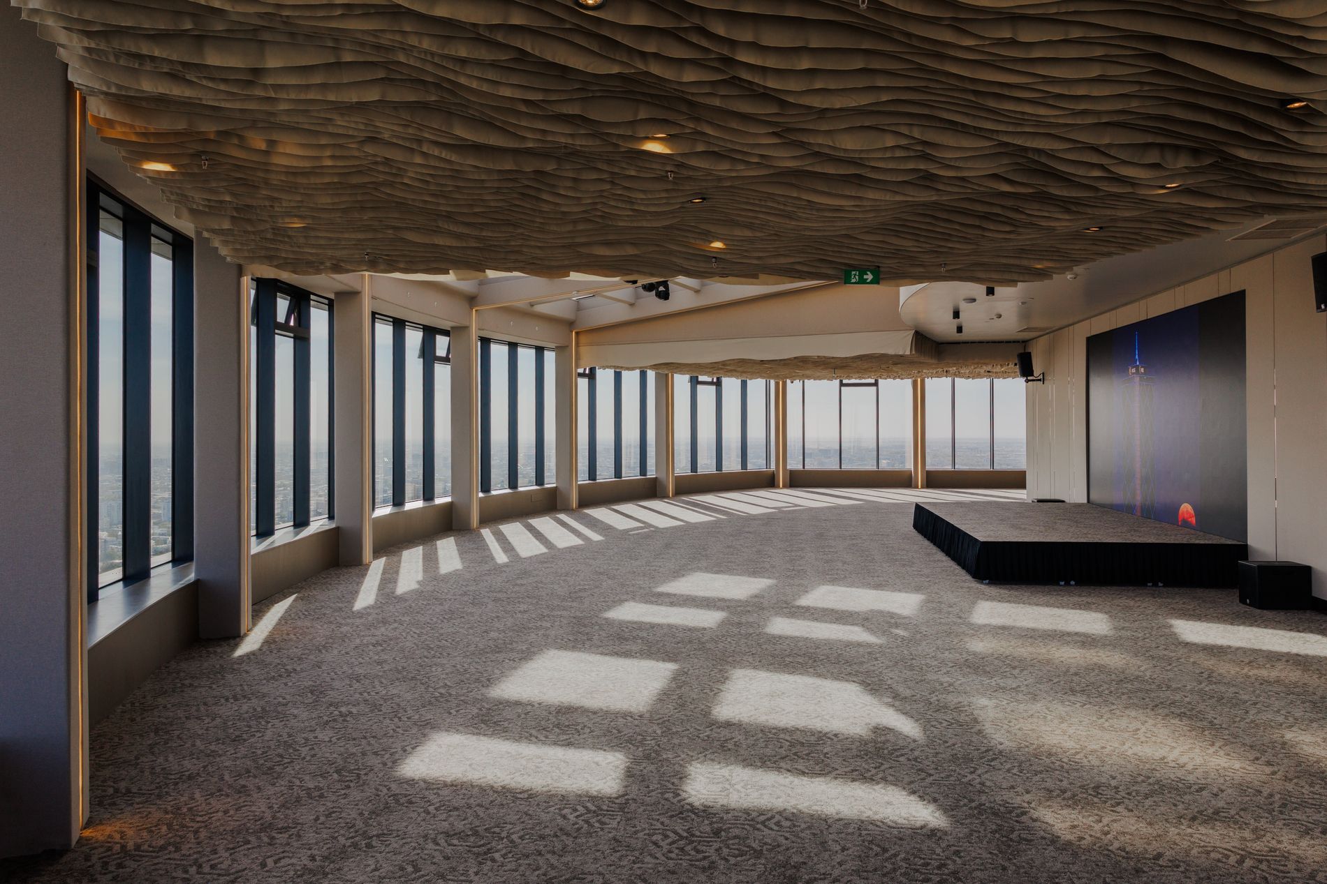 Rooftop Hall — empty venue space at golden hour, floor-to-ceiling panoramic windows over Tashkent