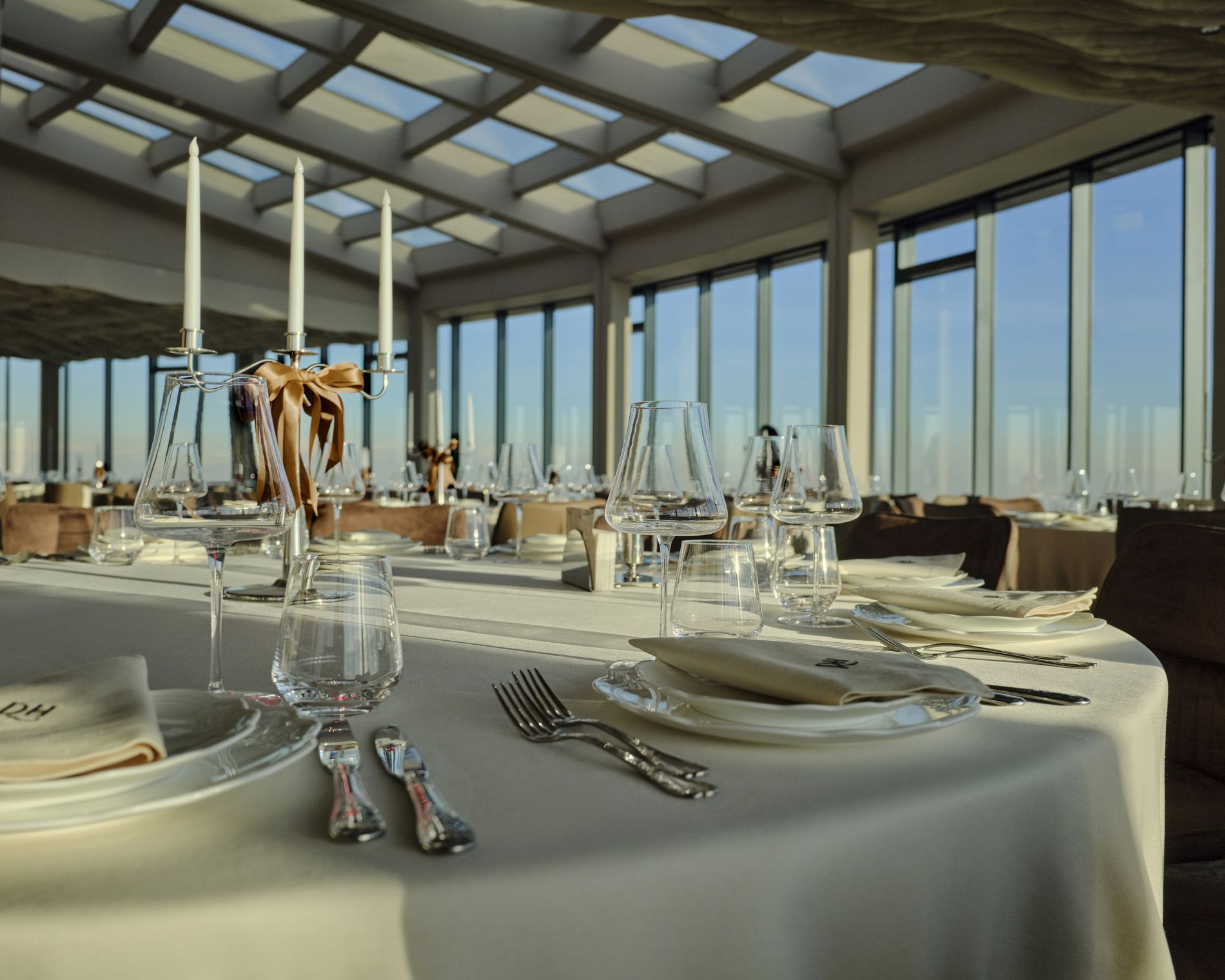Rooftop Hall — candlelit table detail with crystal glassware at golden hour