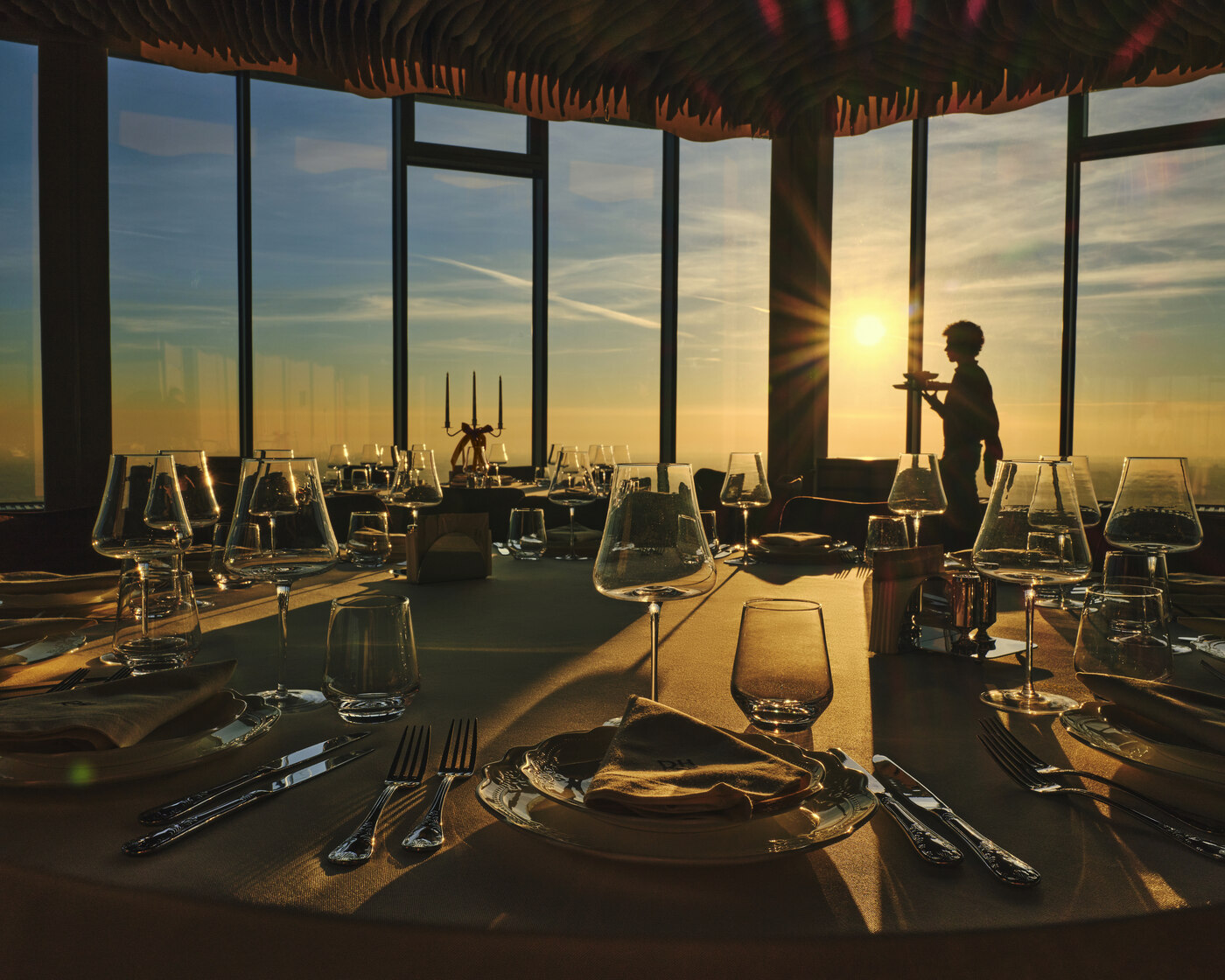 Corporate event at Rooftop Hall — conference setup with LED screen and panoramic city views, 48th floor