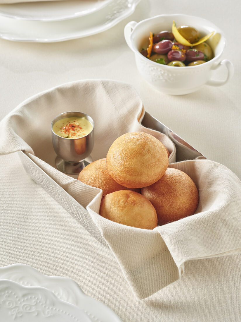 Freshly baked bread rolls served with butter — Rooftop Hall culinary experience