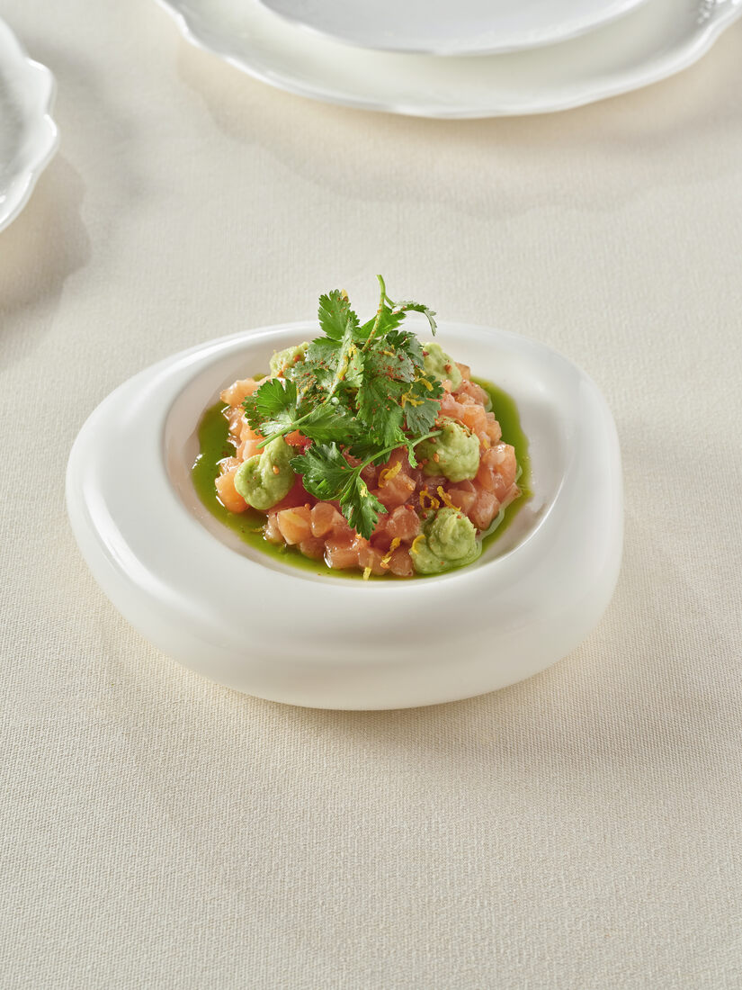 Salmon tartare in a white bowl — clean, precise, composed by the chef team