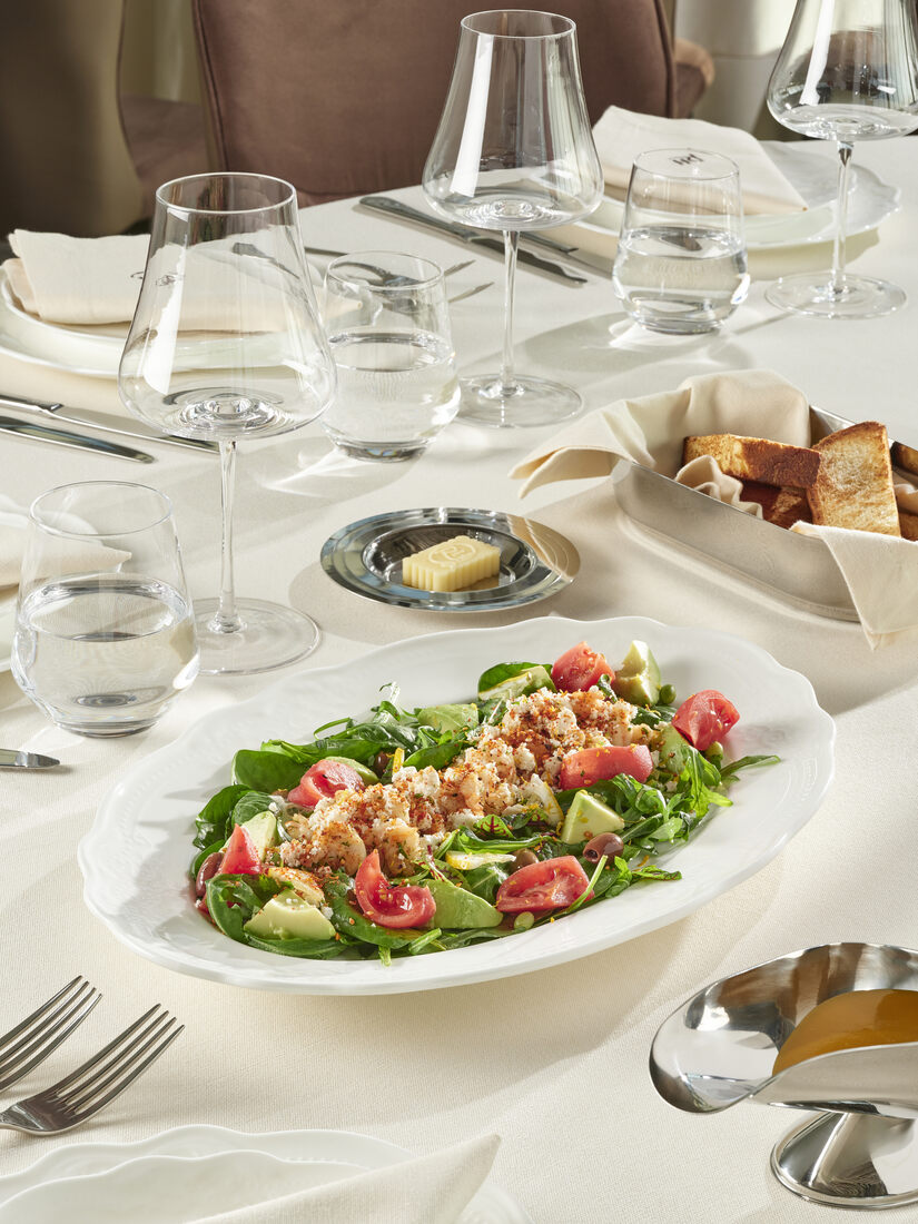 Garden salad with crystal glassware — the table as part of the composition