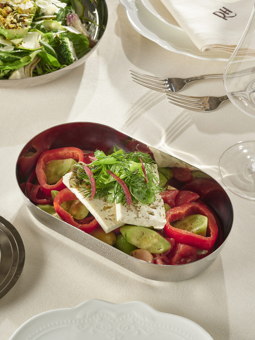 Roasted pepper, feta and herb salad in an oval silver tray